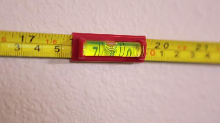 Hang-o-matic: All-in-one Picture Hanging Tool - Picture hanging tools built into tape measure