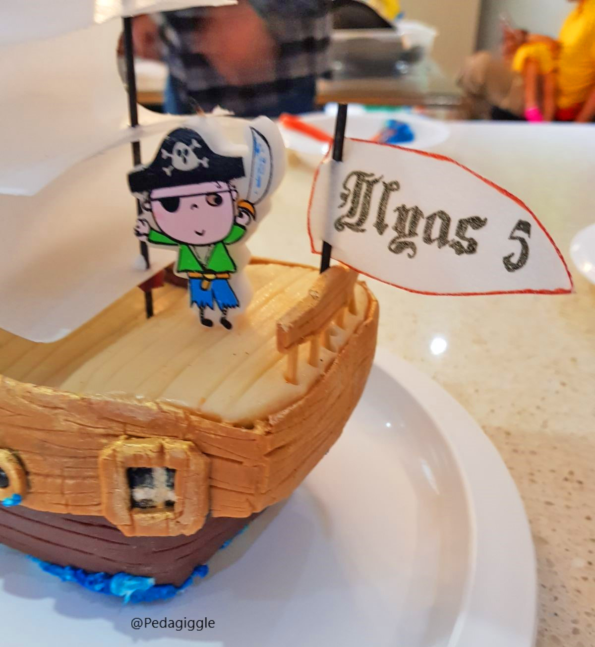 Extravagant pirate ship birthday cake that's being attacked by a giant octopus