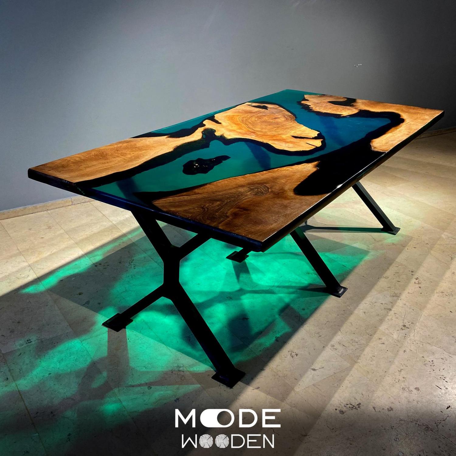 An incredible epoxy/resin table made with walnut wood and resembles islands in a deep blue sea