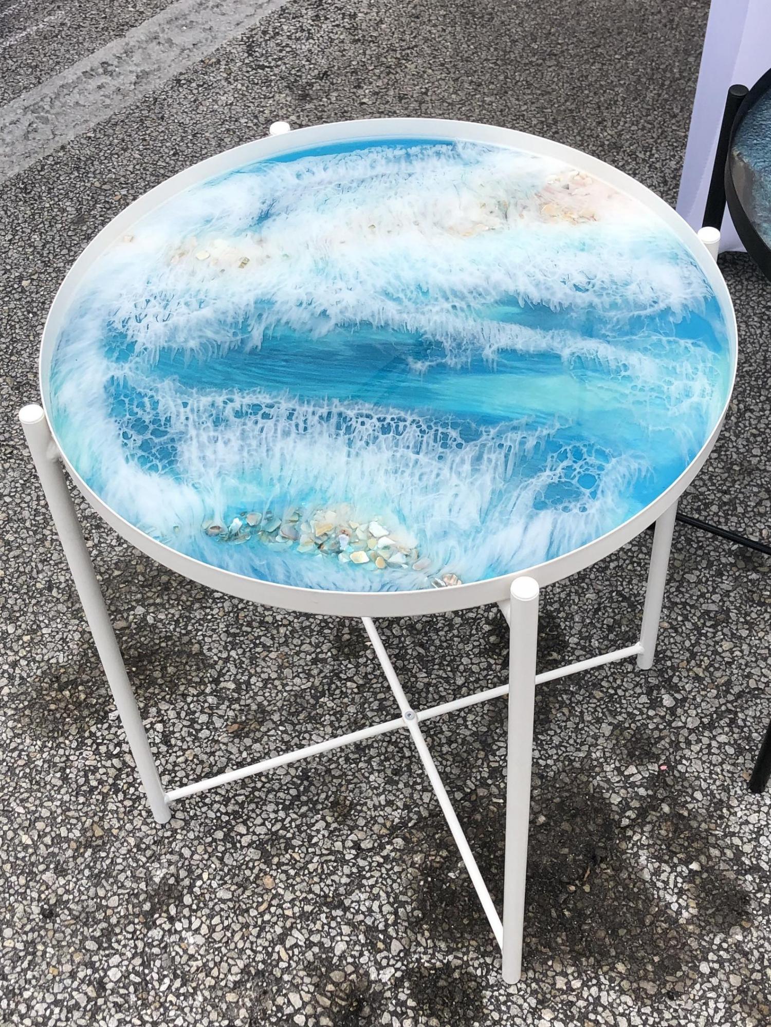 small circular epoxy table is made to look like a piece of art with beautiful ocean waves
