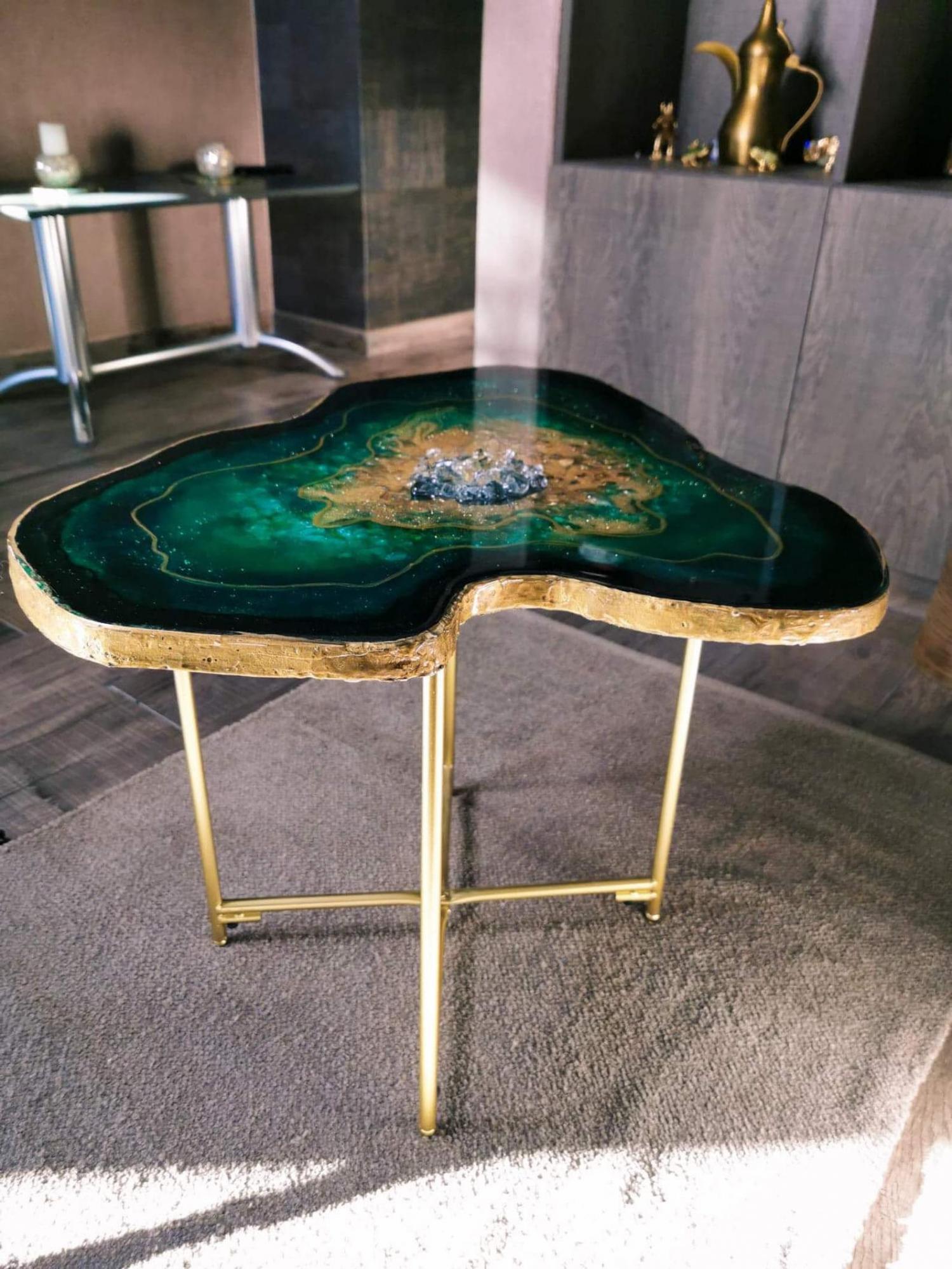 stunning epoxy coffee table is made to resemble a green emerald geode