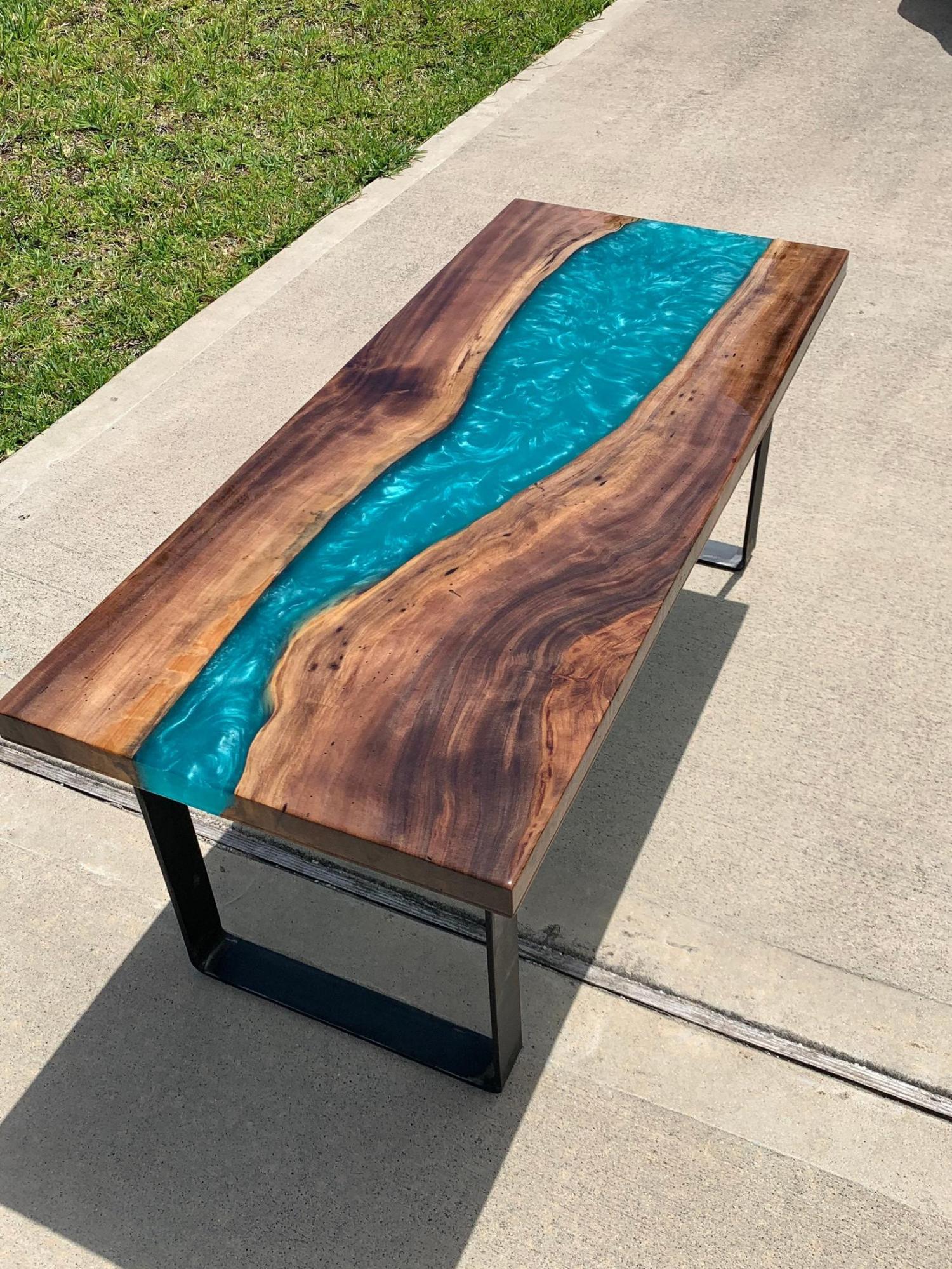 large epoxy table with a beautiful blue river flowing through it