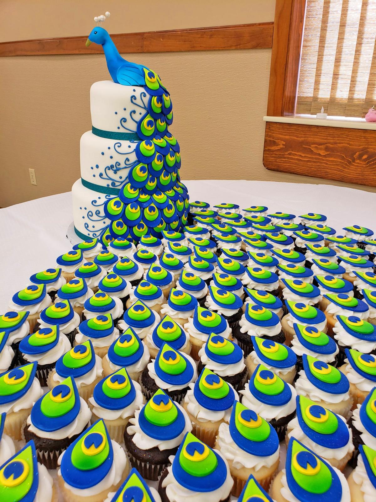Peacock Wedding Cake - Creative three-layer peacock cake uses cupcakes for the tail of the bird