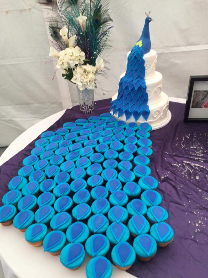 Peacock Wedding Cake - Creative three-layer peacock cake uses cupcakes for the tail of the bird