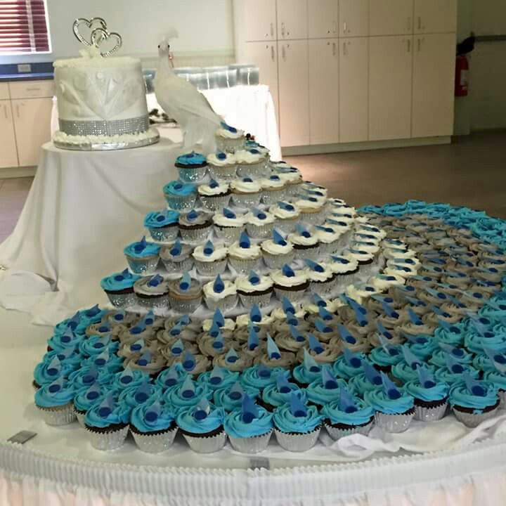 Peacock Wedding Cake - Creative three-layer peacock cake uses cupcakes for the tail of the bird