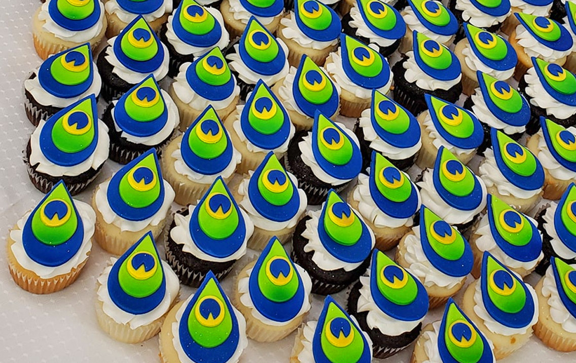 Peacock Wedding Cake - Creative three-layer peacock cake uses cupcakes for the tail of the bird