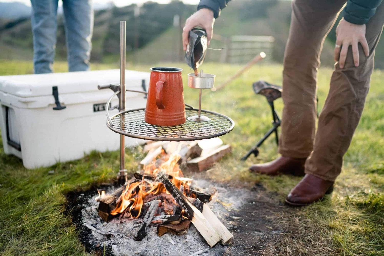  Ultimate Campfire Grill Turns Your Fire Pit Into a Tiered Cooking Machine - Breeo Fire pit cooker with winch