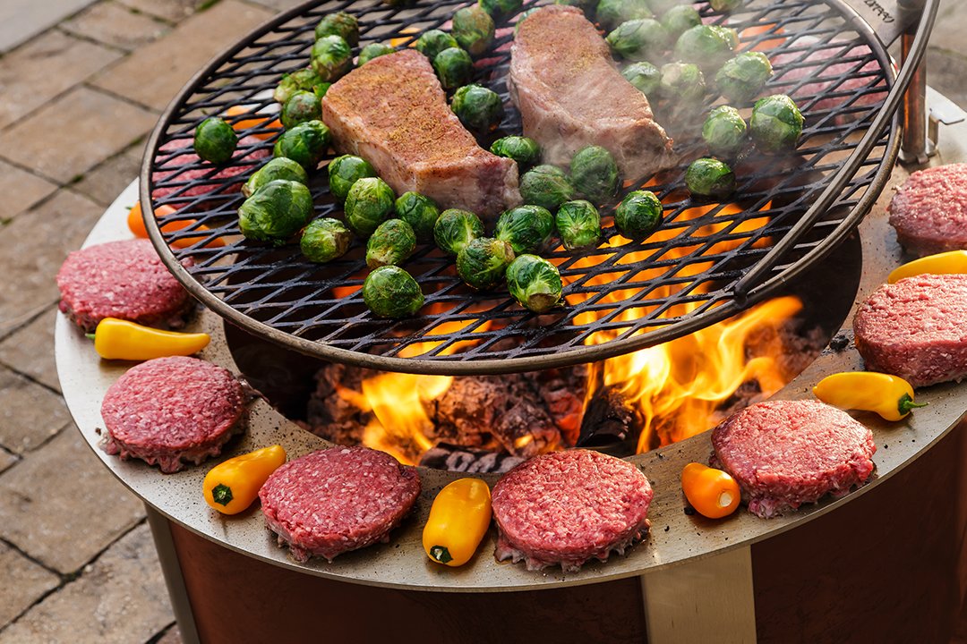  Ultimate Campfire Grill Turns Your Fire Pit Into a Tiered Cooking Machine - Breeo Fire pit cooker with winch