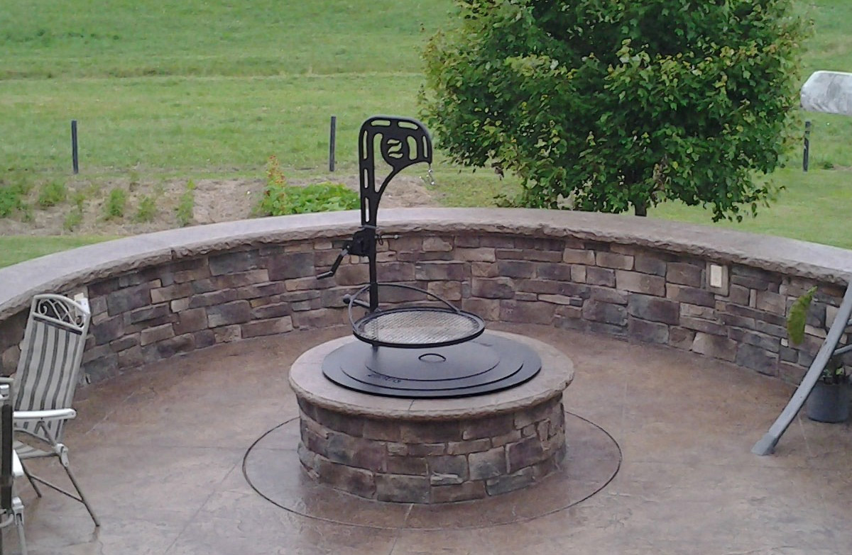  Ultimate Campfire Grill Turns Your Fire Pit Into a Tiered Cooking Machine - Breeo Fire pit cooker with winch